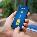 Man hand hold phone with Sim card replacement on eSim