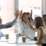 Happy multicultural executive team people give high five celebrate success