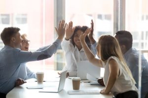 Happy multicultural executive team people give high five celebrate success