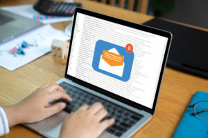 Person using a laptop computer with email communication connecti